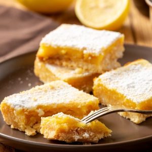 Creamy Lemon Bars, tangy-sweet, buttery crust, velvety lemon filling, citrus flavor, refreshing, foolproof recipe, heavenly, crowd-pleaser, dessert, SEO-optimized, indulgent, tangy, sweet, zesty, delicious.